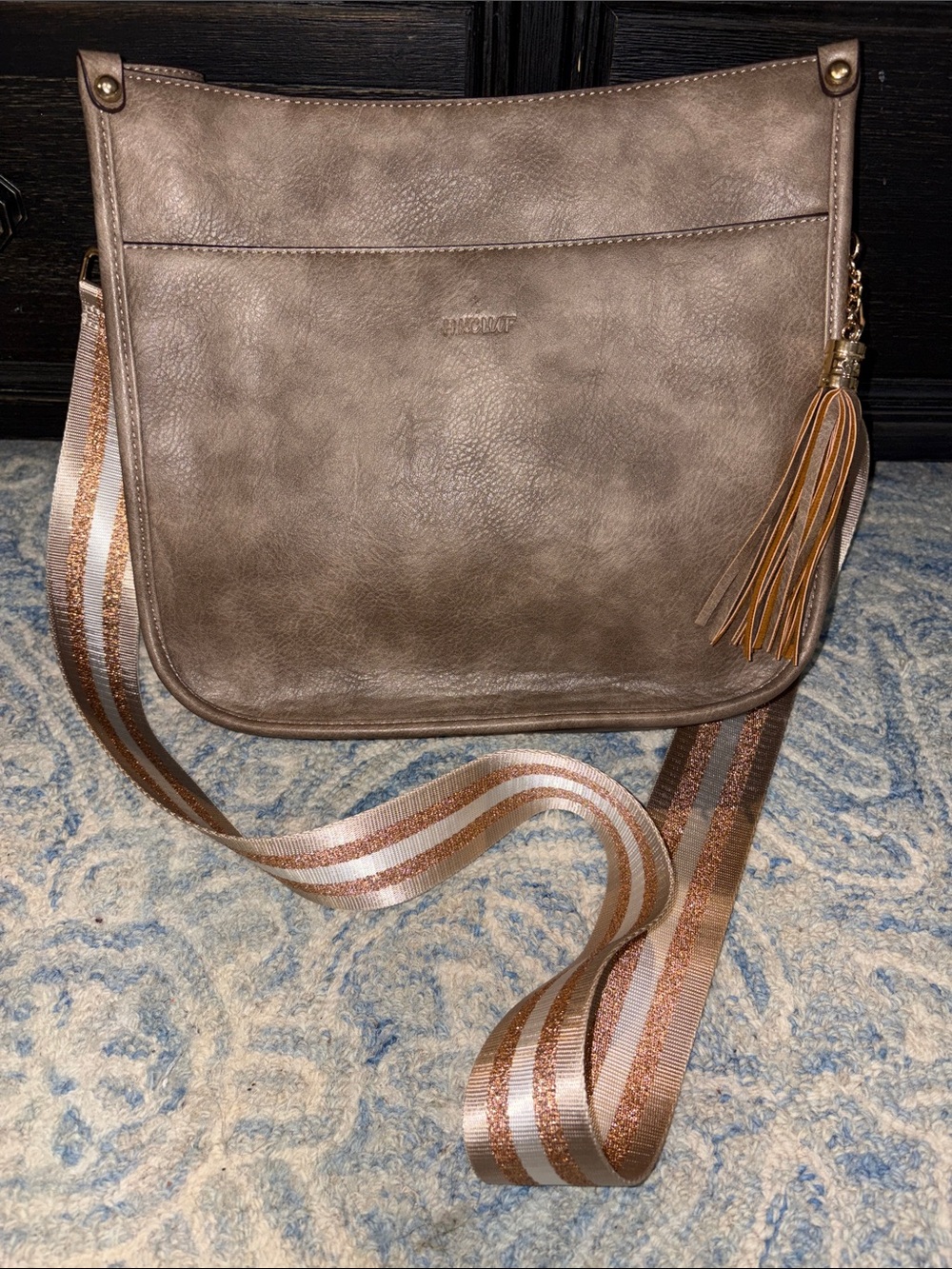 Textured Taupe Crossbody Bag with Striped Web Strap and Tassel
